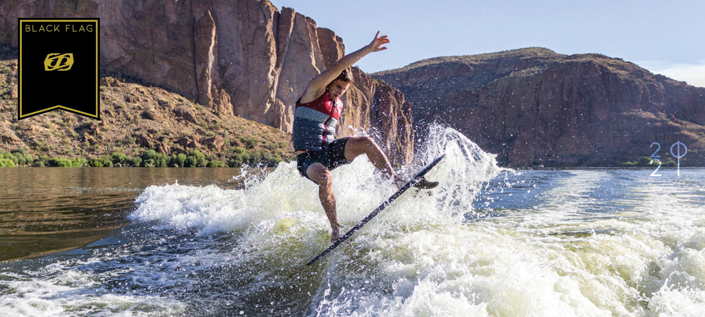 Image showing a wake surfer riding the Jetpilot Black Flag Wake Surfboard.