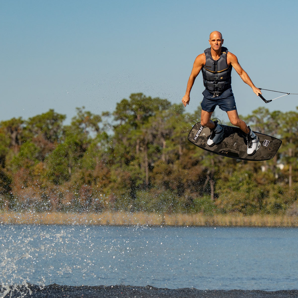 Shaun Murray wakeboarding in the new 2026 Jetpilot Murray vest. #color_gray