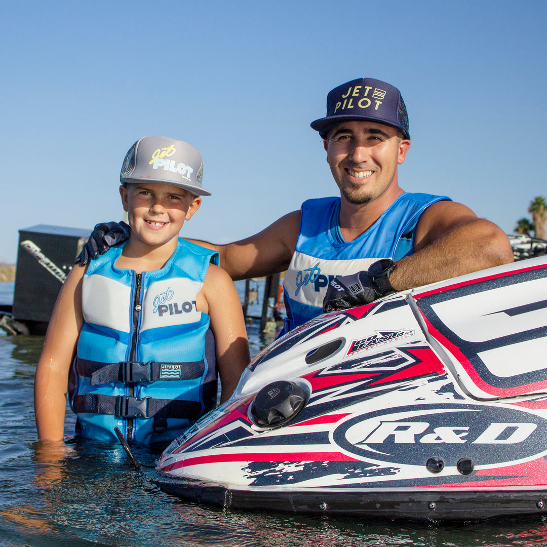 A rider wearing the Youth Vintage Class Neoprene CGA Vest and hats.  