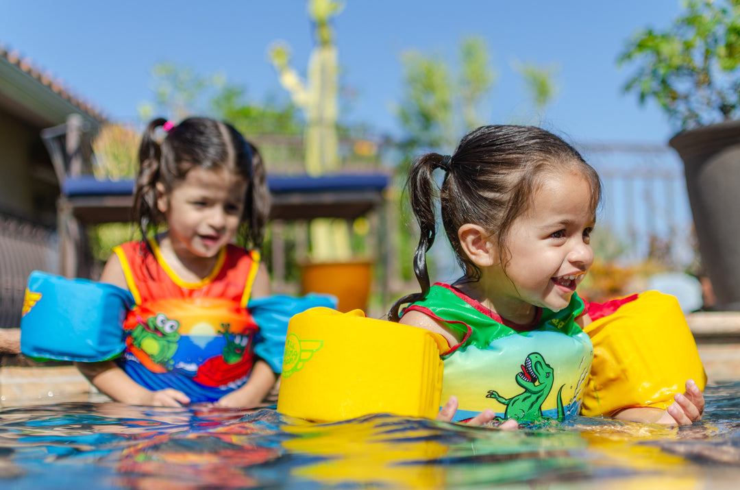 Image of two girls wearing the Jetpilot Lil Wing Man swim vest.