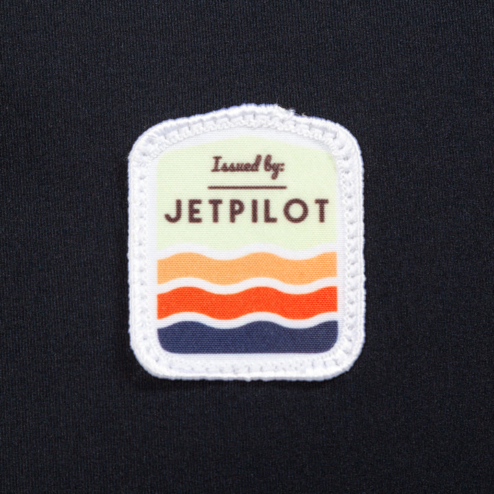 Closeup of the Jetpilot Draftline Comp Vest logo. #color_black-charcoal