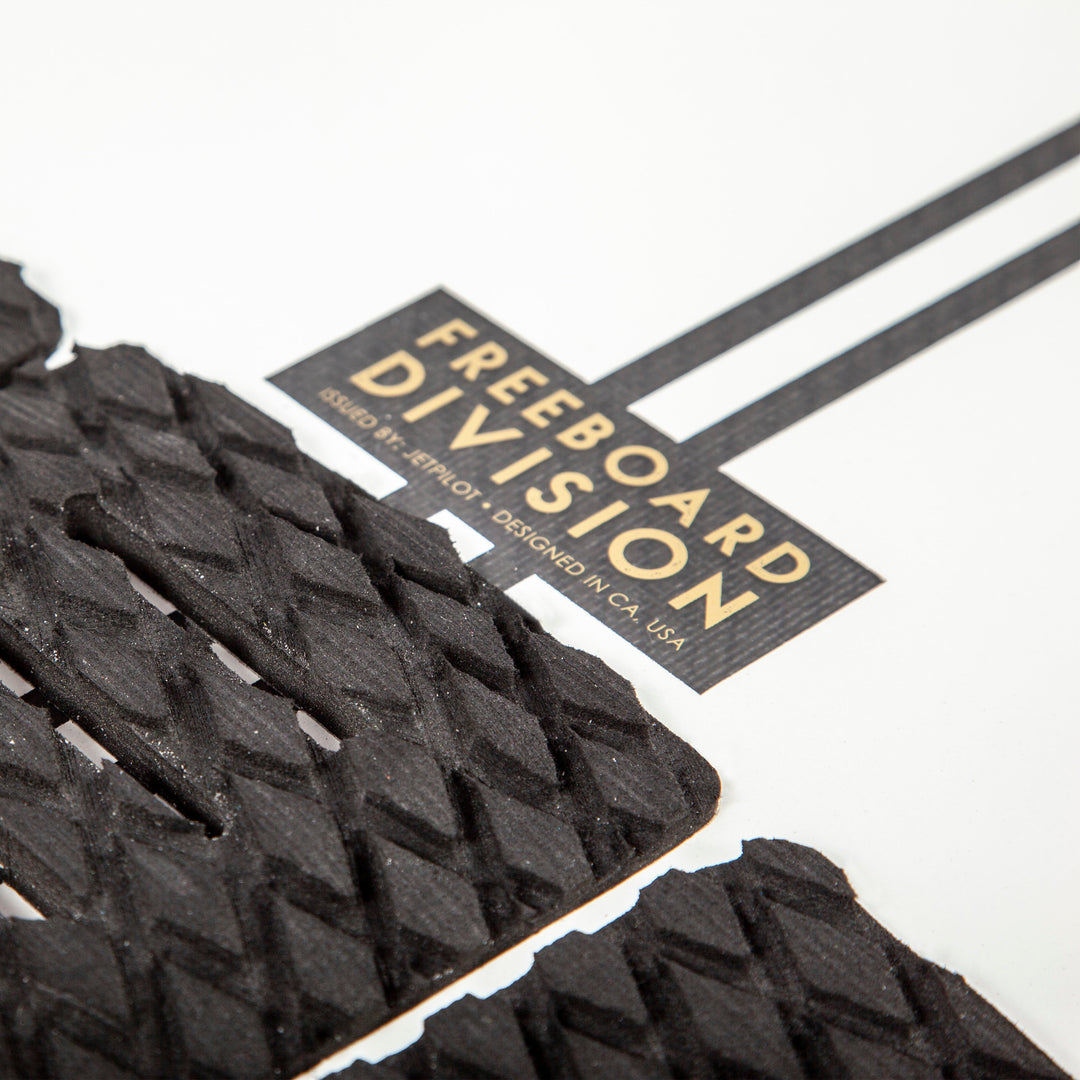 Image of the Freeboard Division logo on the Black Flag wake surfboard.