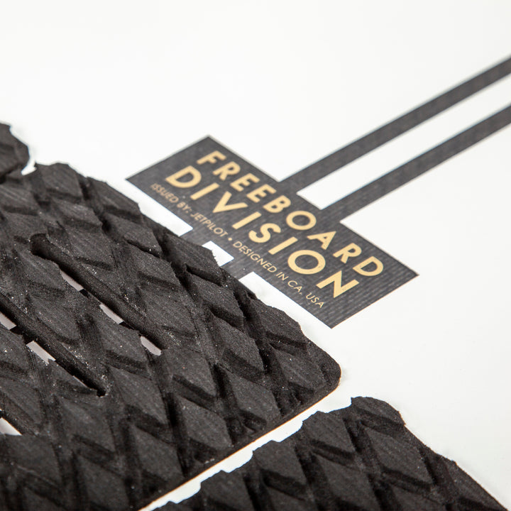 Image of the Freeboard Division logo on the Black Flag wake surfboard.