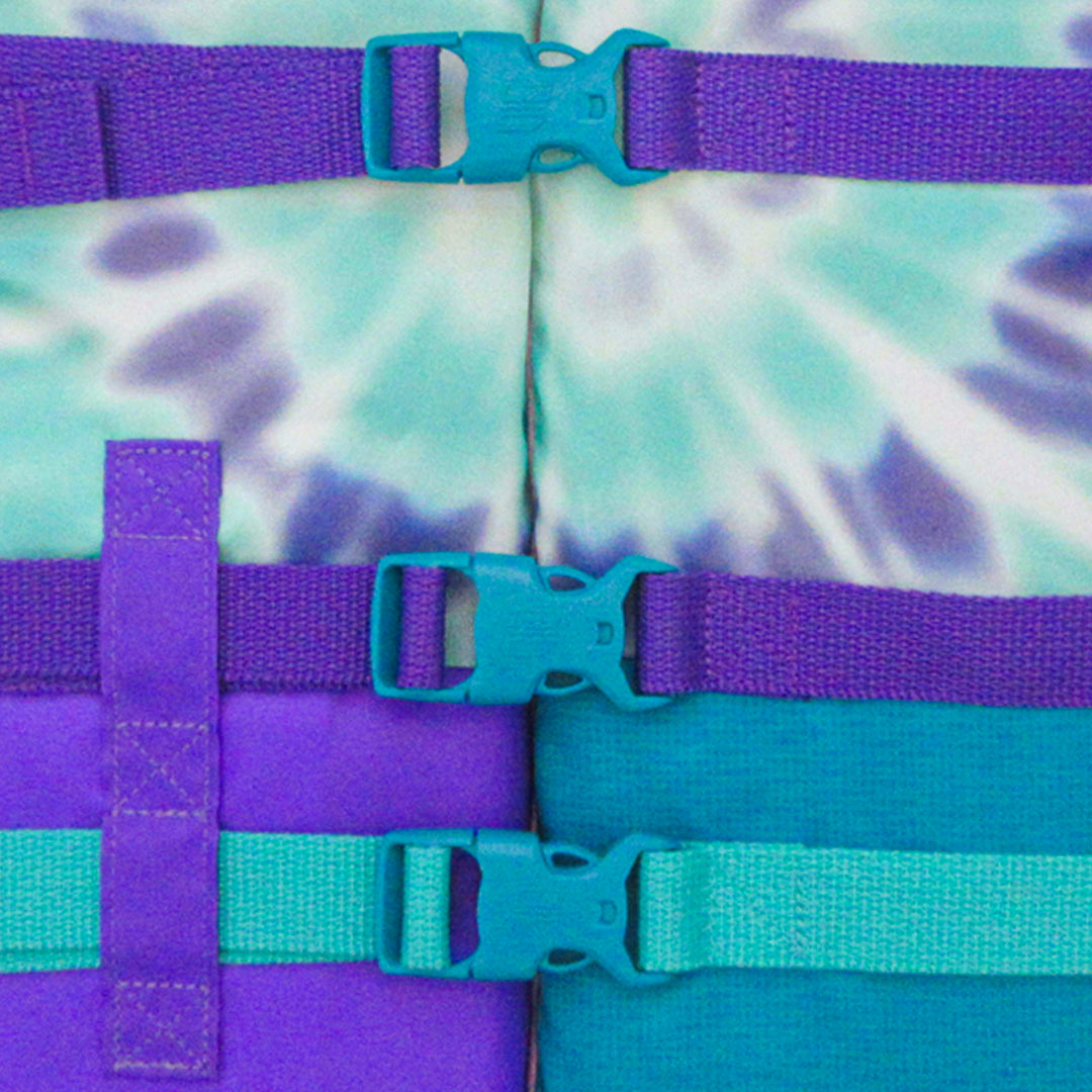 Front bottom view of the youth Jetpilot Pistol CGA vest Teal Purple showing the triple buckle design