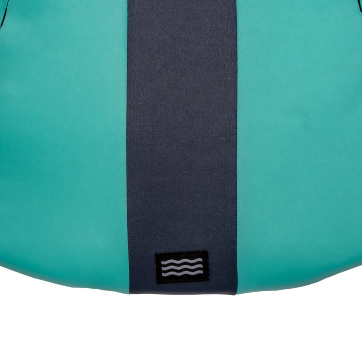 View of the Jetpilot Women's Cause CGA Vest lower back logo. #color_teal