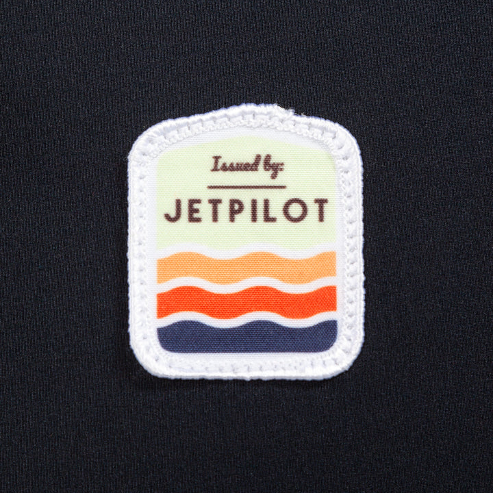 Closeup of the Jetpilot Draftline Comp Vest logo. #color_black-charcoal