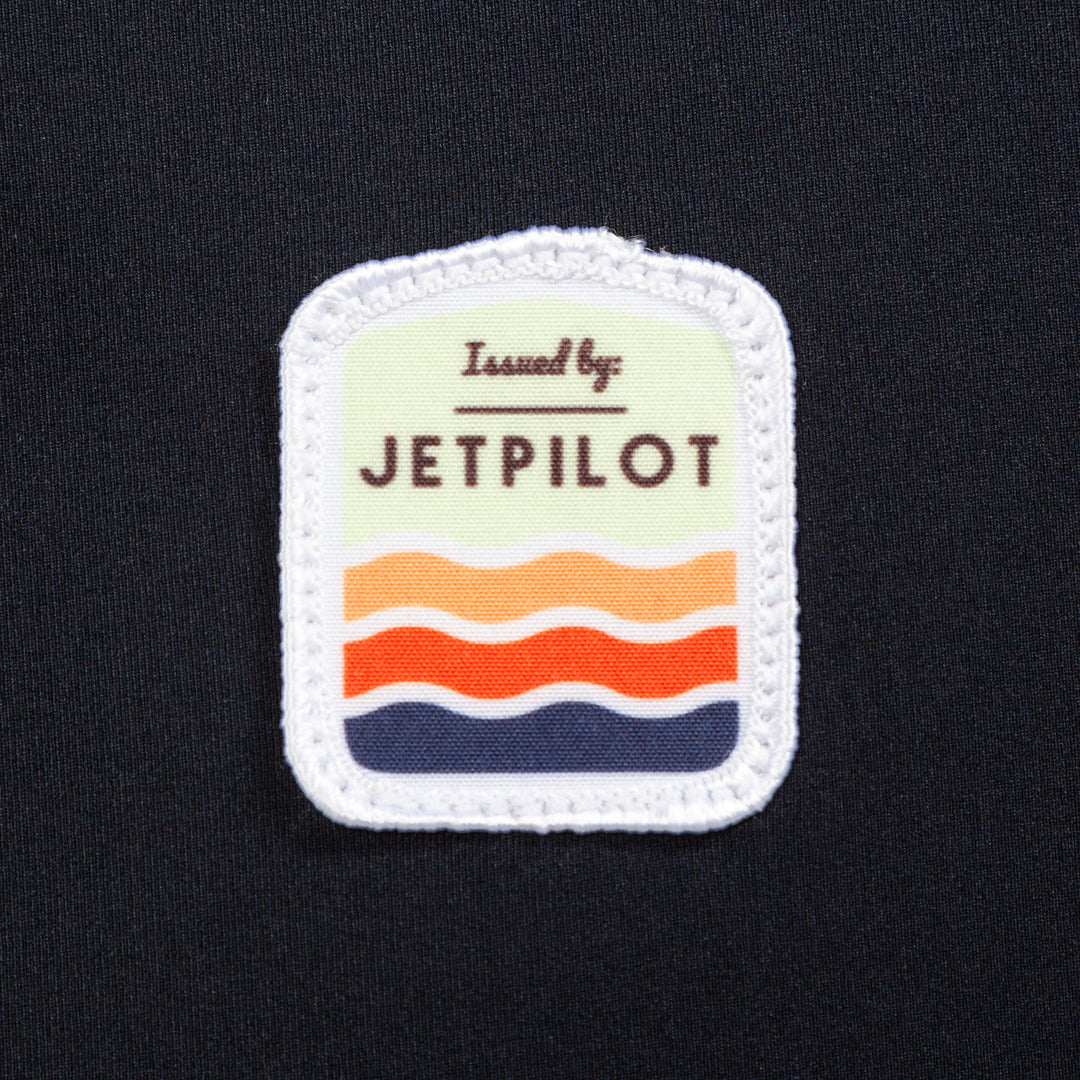 Closeup of the Jetpilot Draftline Comp Vest logo. #color_black-charcoal