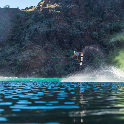 Picture of Shaun Murray doing a noise grab in the air wakeboarding.